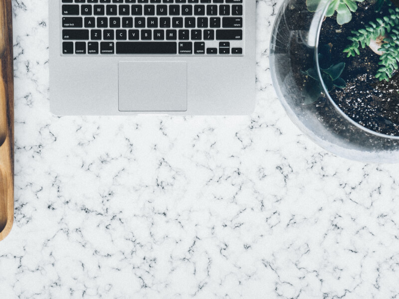 Glass terrarium next to laptop